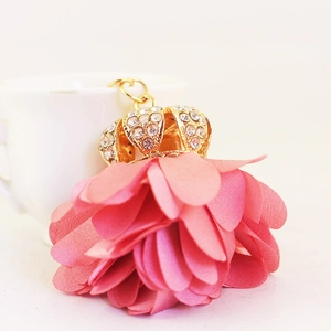 Pink chiffon flower petal keychain with a gold rhinestone-encrusted crown charm