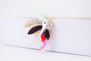 Detailed close-up of crystal rhinestone parrot keychain with colorful enamel coating