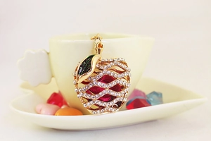 Detail of apple keychain with sparkling rhinestones and red dried flower inside