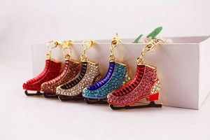 Close-up of sparkling ice skate keychains in five colors with golden hooks