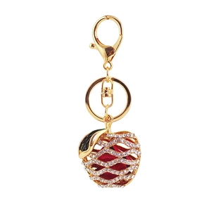Golden apple keychain with crystal rhinestones and a red rose bud flower inside