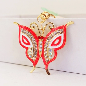 Exquisite gold butterfly keychain with red and white enamel and sparkling rhinestones