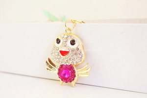 Close-up of crystal chicken keychain with rose red gemstone and shiny rhinestones