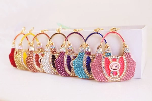 Detail of seven colorful rhinestone-encrusted handbag pendants for keychains or bag decor