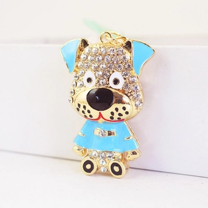 Porte-clés chiot doré avec strass blancs et détails en émail bleu élégant