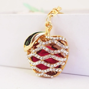 Sparkling rhinestone apple keychain with real red dried flower inside on a gold metal ring