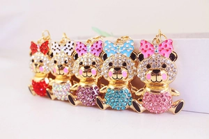 Detail of five rhinestone bear keychains in colorful bow styles and glitter finishes