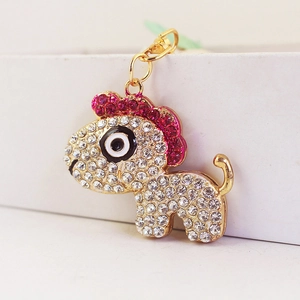 Cute golden horse keychain with sparkling white and rose red rhinestones on white box