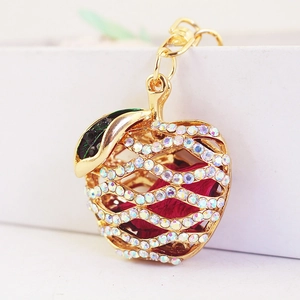 Sparkling apple keychain with colorful rhinestones and dried flowers on a golden clasp
