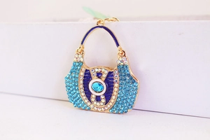 Detail of blue rhinestone handbag keychain with gold plating and fine crystal inlay