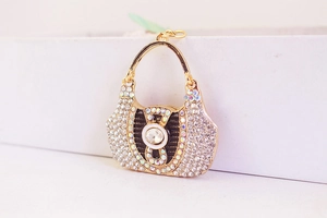Macro shot of gold purse keychain with sparkling rhinestones and crystal centerpiece
