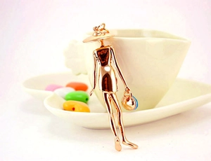 Close-up of elegant rose gold handbag keychain pendant with stylish lady silhouette
