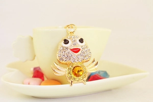 Detailed view of creative crystal chicken keychain with rhinestones and amber gemstone