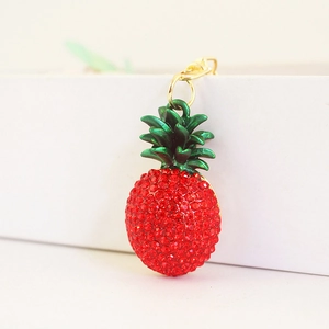 Sparkling red rhinestone pineapple keychain with green leaves and golden lobster clasp