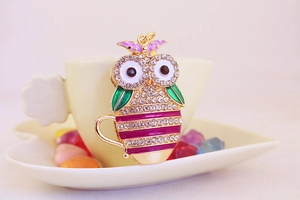 Detailed view of owl tea cup pendant with colorful enamel and crystal rhinestones