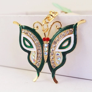 Sparkling crystal butterfly keychain in gold metal with dark green enamel finish