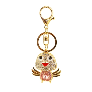 Macro detail of golden chick keychain with pink crystal heart and rhinestone inlay