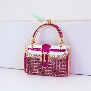 Exquisiter goldener Handtaschen-Schlüsselanhänger mit lila Strass und Emaille