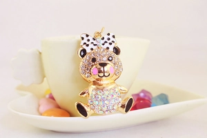 Close-up of bear keychain with crystal rhinestones, enamel finish and polka dot bow