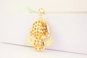 Detailed back view showing gold metal heart pattern hollow carving on chick pendant