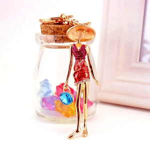 Creative rhinestone lady keychain with wide-brimmed hat and large blue gemstone charm