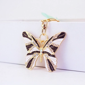 Porte-clés papillon étincelant avec strass et détails en émail sur base dorée