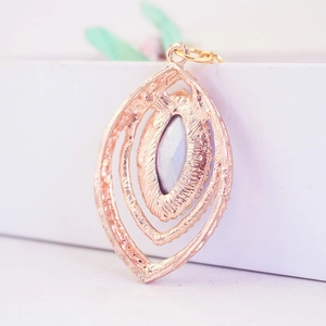 Peacock feather pendant keychain with rose gold plating and grey gemstone back view