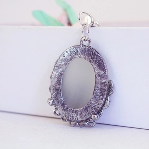 Retro oval alloy pendant with textured surface and beaded edge for DIY jewelry making