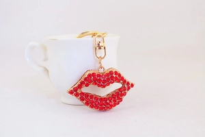 Close-up of red rhinestone lips keychain with gold metal frame and lobster clasp