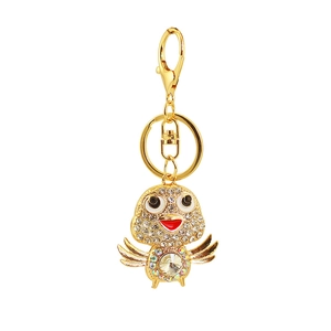Golden chicken keychain with white rhinestones and large faceted colorful crystal gemstone