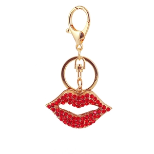 Detailed macro view of high-shine gold lobster clasp and red rhinestone lip pendant