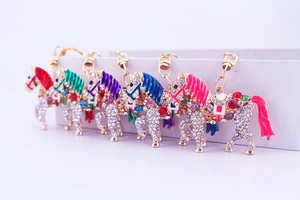 Detailed view of horse-shaped rhinestone keychains in five vibrant colors and gold alloy