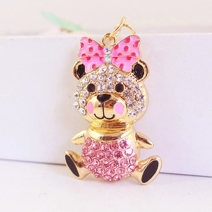Golden sitting bear keychain with sparkling rhinestones and pink polka dot bow decoration