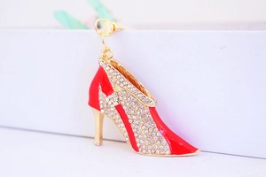 Detail view of high heel keychain with red enamel and shimmering white rhinestones