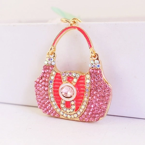 Charming pink rhinestone handbag keychain with gold metal frame and enamel details