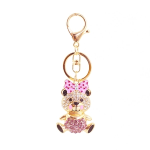 Sparkling crystal rhinestone teddy bear keychain with pink bow on white background