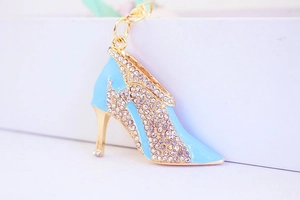 Detail of light blue enamel high heel keychain with white rhinestones and gold plating