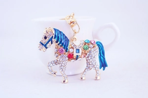 Detailed close-up of a horse keychain with colorful rhinestones and blue enamel details