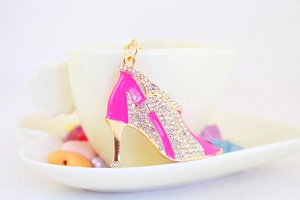 Close-up of pink high heel keychain with sparkling rhinestones and golden metal details