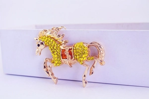 Detailed view of horse keychain featuring yellow rhinestones and gold plating