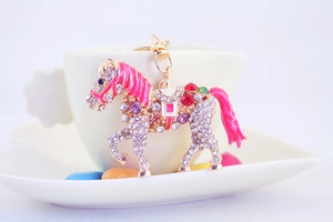 Detail of horse-shaped keychain with multi-color rhinestones and golden metal lobster clasp