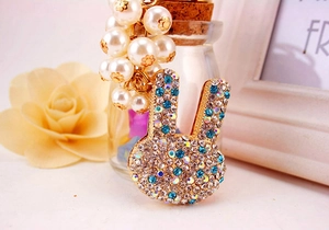 Détail d'un pendentif lapin serti de strass bleus et blancs avec perles de culture