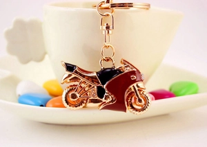 Macro di un portachiavi da moto con strass appeso a una tazza da caffè in ceramica