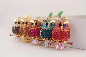 Detailed macro view of colorful rhinestone owl keychains in multiple vibrant color variants