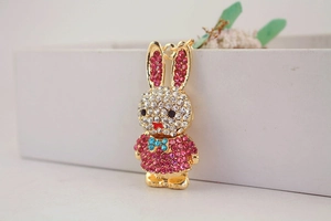 Close-up of sparkling rhinestone bunny keychain with colorful crystals on golden metal