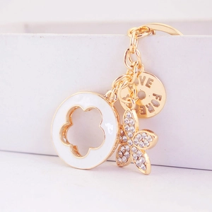 Golden flower keychain with rhinestones, enamel ring, and Love Forever engraved charm