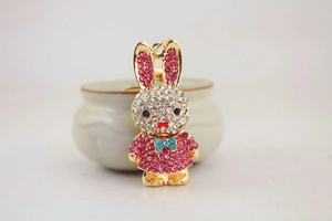 Detail of cute rhinestone rabbit keychain with pink ears and sparkling gold metal plating