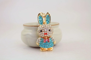 Close-up of sparkling rhinestone bunny keychain with blue and white crystals on gold metal