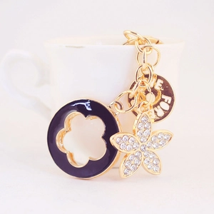 Golden keychain with diamond flower, black enamel ring and Forever engraved pendant