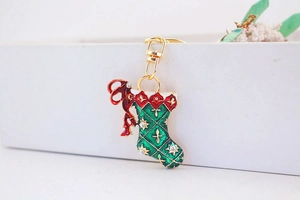 Detailed macro view of Christmas stocking keychain with red bow and sparkling rhinestones